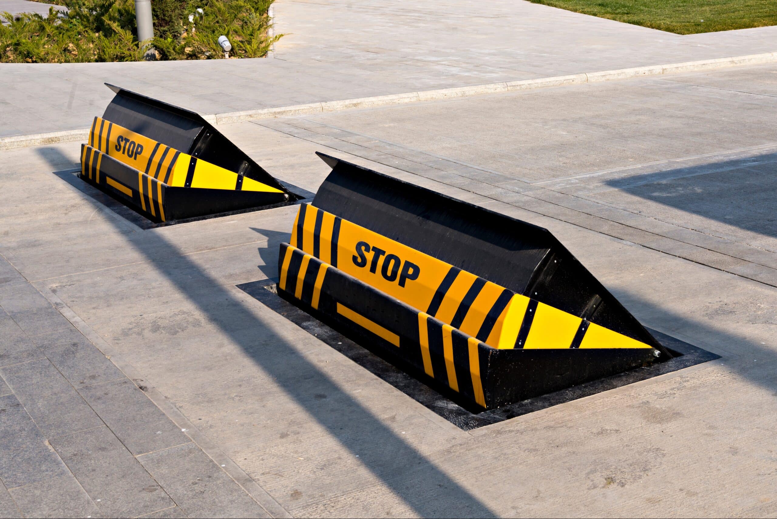 Wedge barriers blocking vehicle threats in a high-security zone.