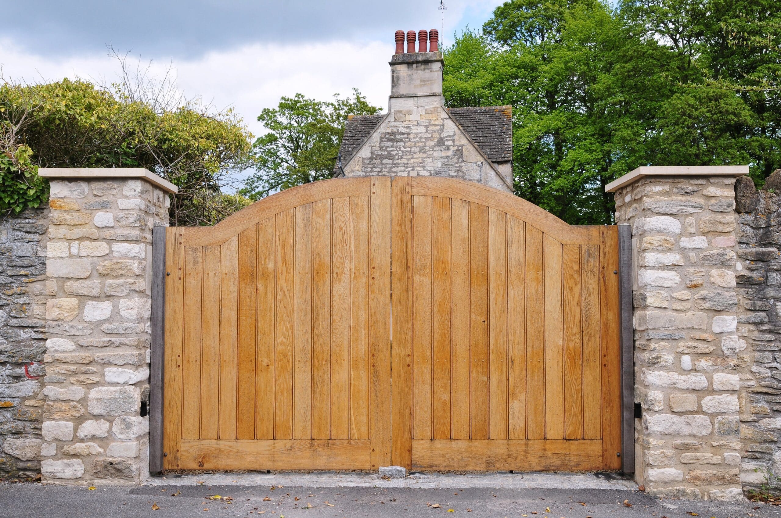 Wooden driveway gate by R3 Access Inc., offering privacy, style, and curb appeal.