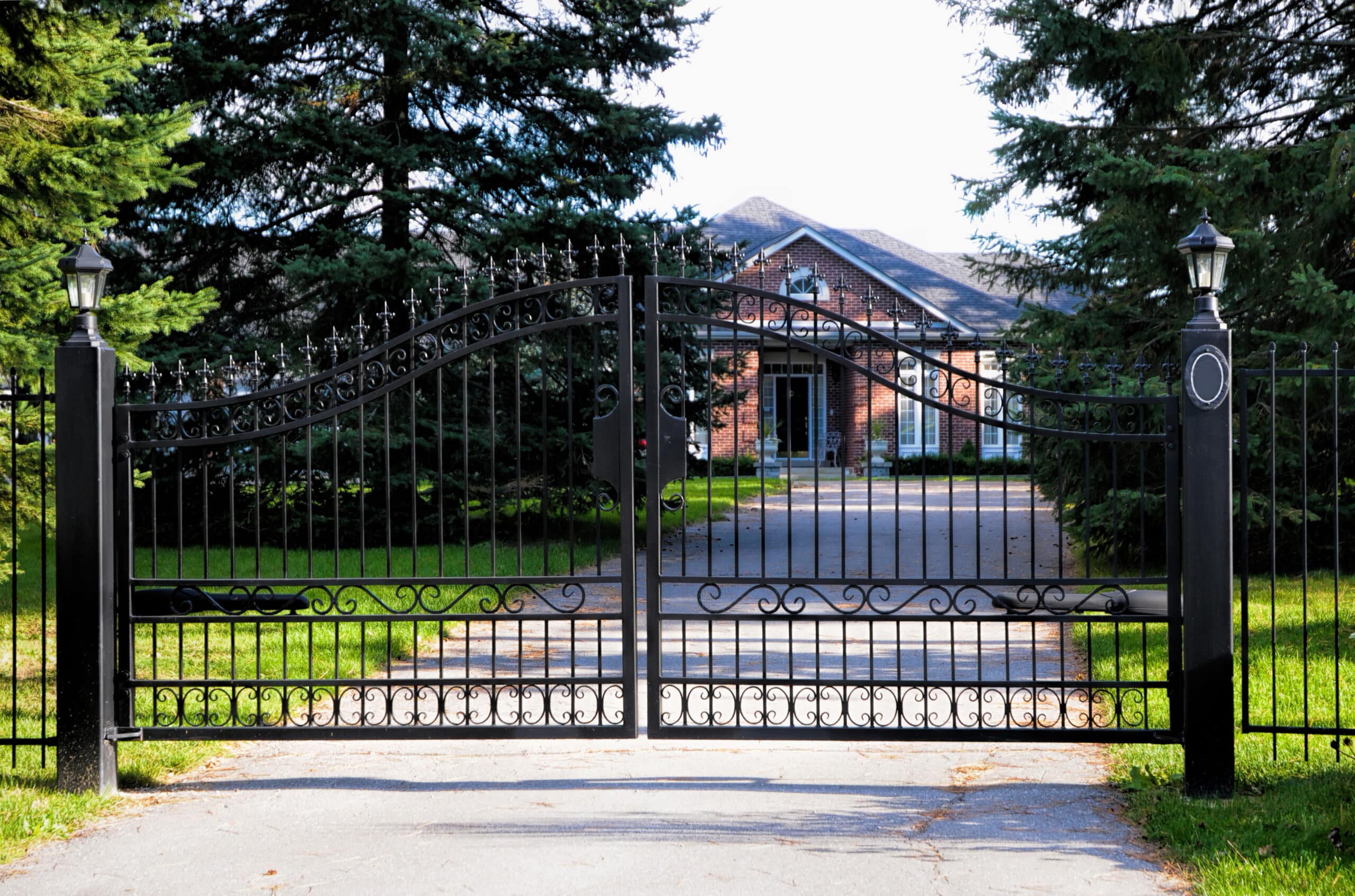 Wrought iron driveway gate by R3 Access Inc., combining security and elegance.