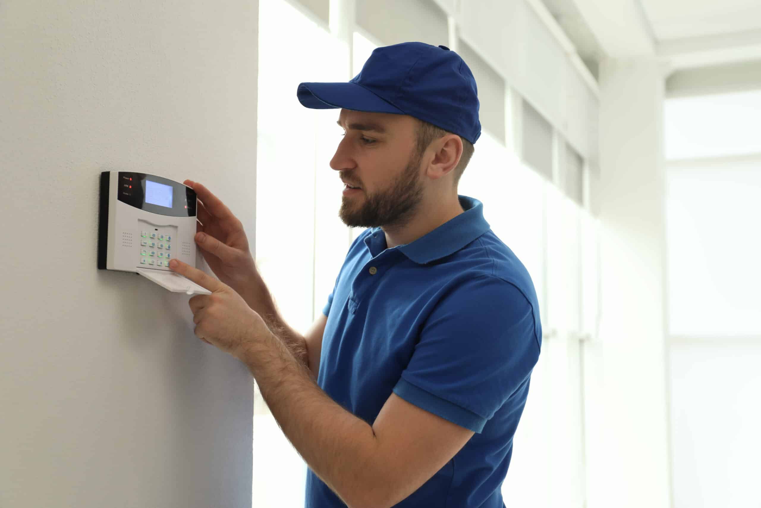 A security specialist configuring an access control system keypad for secure entry and restricted access.